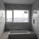Bianco Carrara Bolder Stone Panels installed in a bathroom