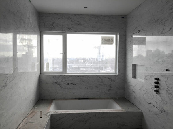 Bianco Carrara Bolder Stone Panels installed in a bathroom