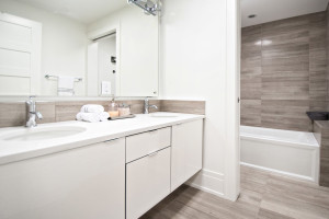 Livingstone bathroom completed, with wooden white marble installed on floors, backsplash and walls