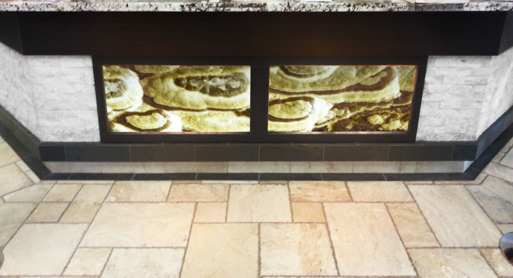 Grey Cloud Bolder Stone Panel - Onyx Series - installed and backlit in a counter